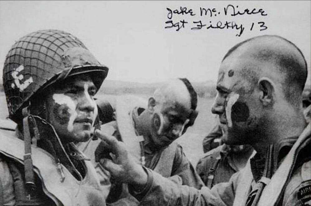 Members of the 101st Airborne Division apply war paint on D-Day