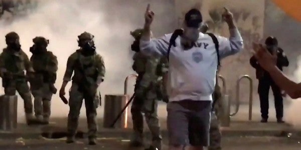 Watch this Navy veteran shrug off batons and pepper spray like a badass amid protests in Portland