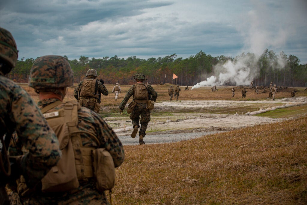 U.S. Marines with India Company, 3rd Battalion, 6th Marine Regiment, 2d Marine Division advance towards an objective during a live-fire assault on range Golf-36 (G-36), Camp Lejeune, North Carolina, Dec. 12, 2020. Range G-36 is the newest addition to the Camp Lejeune training environment. This range is designed to accommodate company-size assaults and evolutions. (U.S. Marine Corps photo by Lance Cpl. Jacqueline Parsons)