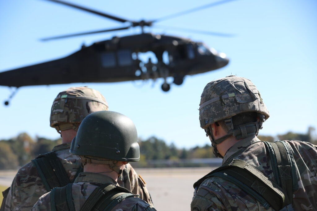 A group of U.S. Army Soldiers, assigned to the 5th Ranger Training Battalion, waits on the Landing Zone to conduct a Speical Patrol Insertion/Extraction (SPIES) attached to a UH-60 Black Hawk Helicopter, assigned to Charlie Company, 1st Battalion, 106th Aviation Regiment during FRIES/SPIES Training at the Army Aviation Support Facility, Winder, GA., November 2, 2018. This training allows both Aviators and Soldiers to perfect their skills to prepare for future mission success. (U.S. Army photo by Staff Sgt. Austin Berner)