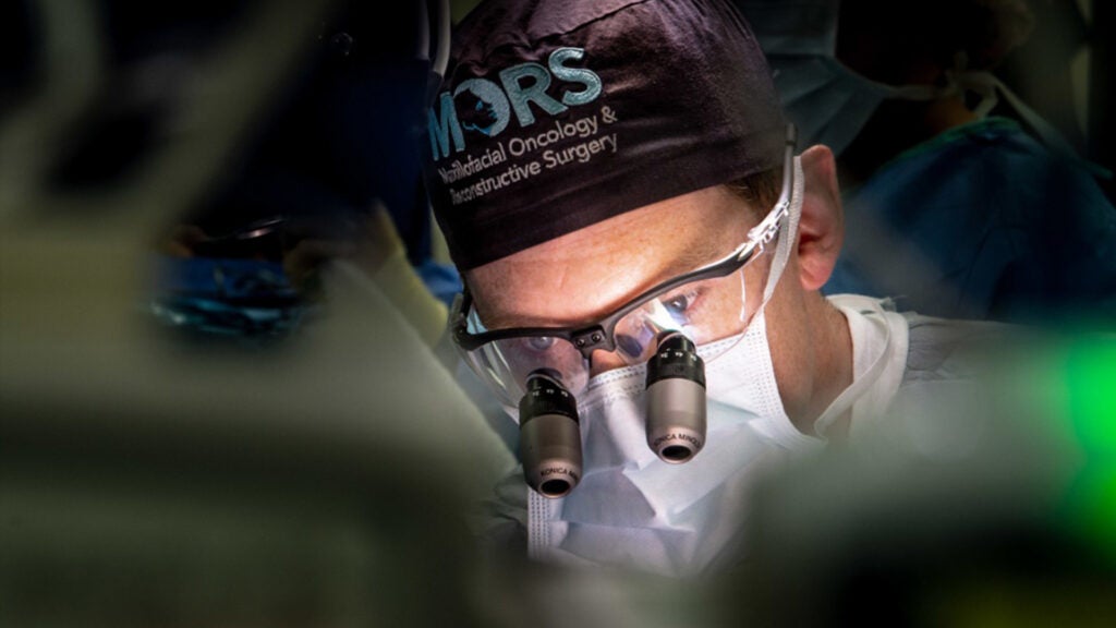 Lt. Cmdr. Daniel Hammer, a maxillofacial oncologist and reconstructive surgeon assigned to Naval Medical Center San Diego (NMCSD), performs an immediate, jaw reconstruction procedure in one of NMCSD’s operating rooms Nov. 18. (Navy photo / Mass Communication Specialist 3rd Class Jake Greenberg)