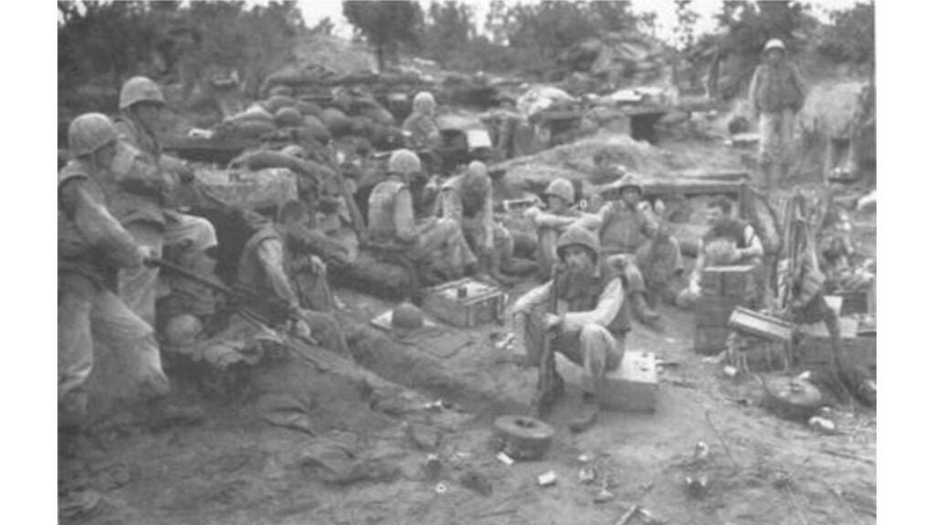 Tired Marines of Company F, 2d Battalion, 1st Marines, unwind during a pause in the fighting on Bunker Hill in Korea, Aug. 13, 1952. Tank, artillery, air and ground Marines participating in the battle gave up one outpost but took another, one that added strength not only to the outpost defense but also to the main line. (DoD photo)