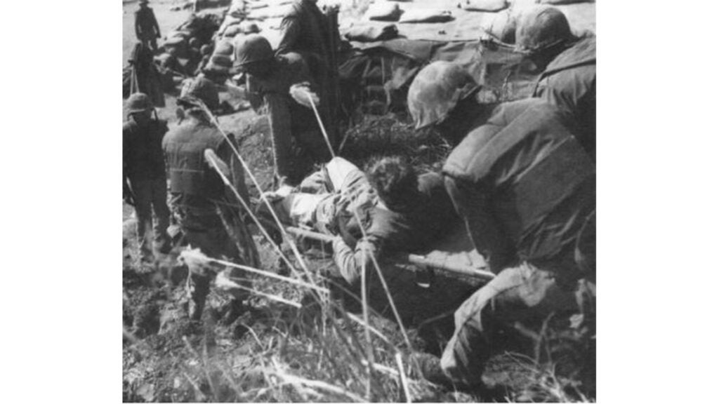 A Marine casualty arrives at a rear aid station in Korea for emergency treatment and evacuation to a hospital in 1952. (DoD photo)