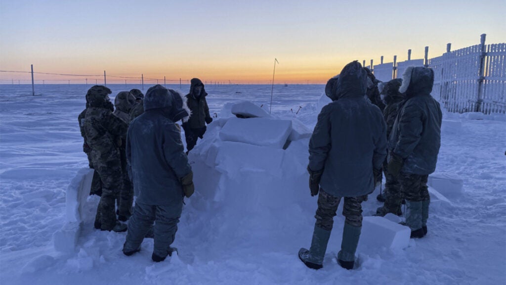 Survival, evasion, resistance and escape (SERE) specialists going through upgrade training learn how to construct an igloo on Utqiaġvik (Barrow), Alaska, Jan. 14, 2021. Igloos were originally used by the Inuit tribe of northern Alaska and are still in use today. They provide warmth and shelter from extreme winds and sub-zero temperatures. (Air Force photo / Master Sgt. Ryan M. Dewey)