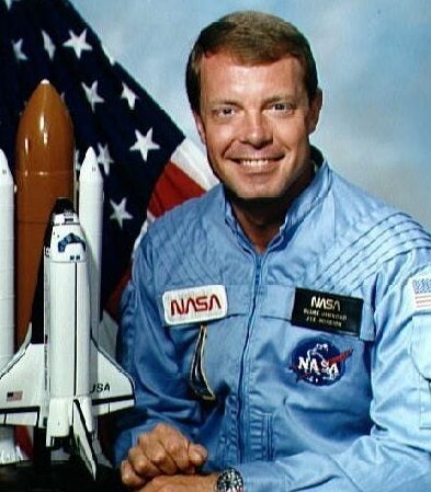Official portrait of Astronaut L. Blaine Hammond dressed in blue flight suit, with flag and a Space Shuttle model (left).

NASA Identifier: NIX-S84-40241