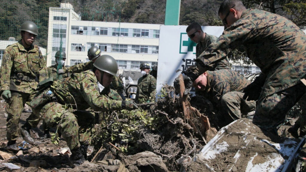 U.S. Marines and Japanese soldiers clear debris at Minato Elementary School in Ishinomaki, Japan, April 1, 2011. (Marine Corps photo / Cpl. Patricia D. Lockhart)