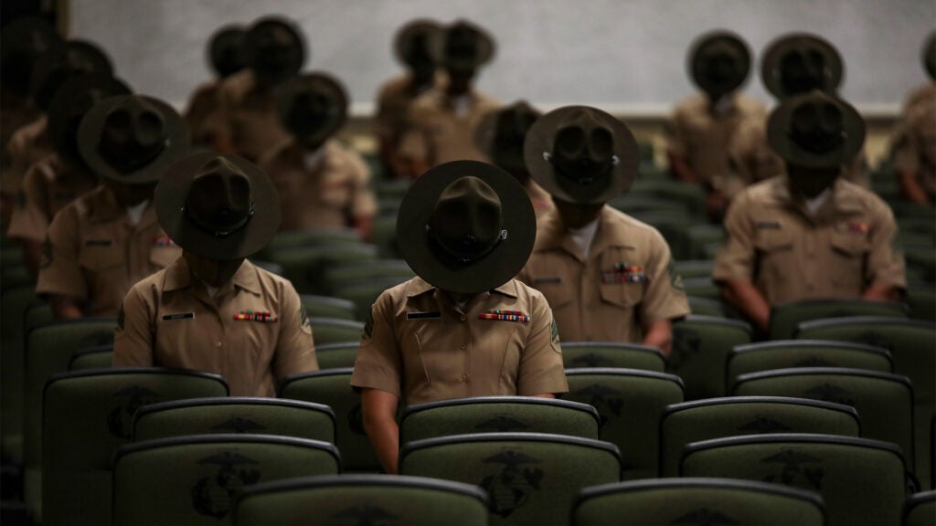 Graduates from Drill Instructor class 3-20 pause for a moment of prayer before their
graduation ceremony on Marine Corps Recruit Depot Parris Island, S.C. June 18, 2020. The mission of Drill
Instructor School is to further develop the leadership, command presence, instructional ability, knowledge,
and physical condition of the selected noncommissioned officers, staff noncommissioned officers to
successfully perform the duties of a drill instructor. (Sgt. Dana Beesley / Military Visual Awards)