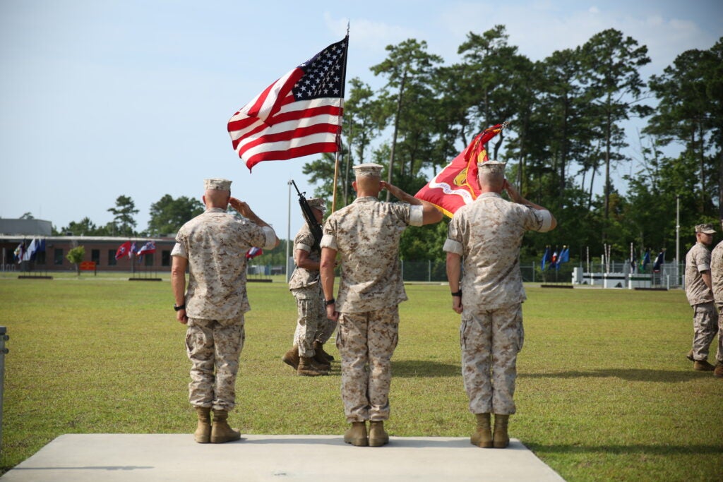 (Left to right) Colonel Andrew R. Milburn, the outgoing Marine Raider Regiment commander, Col. Peter Huntley, the oncoming Marine Raider Regiment commander, and Maj. Gen. Joseph L. Osterman, Marine Corps Forces Special Operations Command commander, salute the colors during the pass and review of the MRR change of command ceremony at the MARSOC headquarters at Stone Bay, aboard Marine Corps Base Camp Lejeune, N.C., June 26, 2015.