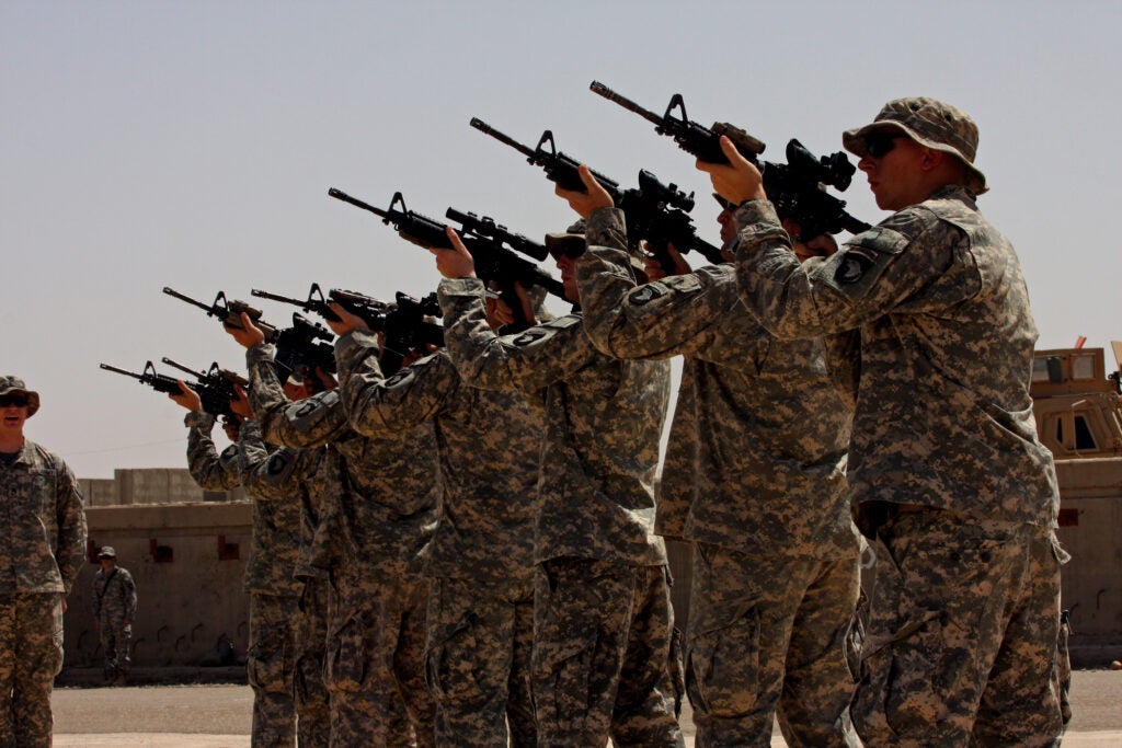 "No Slack" Soldiers from 2nd Battalion, 327th Infantry Regiment, 1st Brigade Combat Team, 101st Airborne Division (Air Assault) render a 21-gun salute at Forward Operating Base Summerall, Iraq, in honor of a fallen brother.