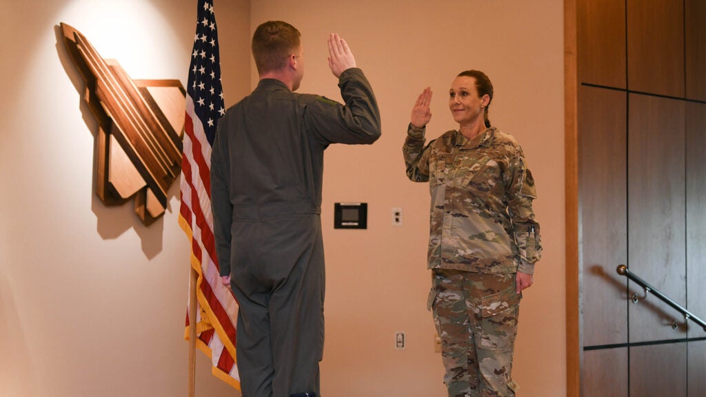 .S. Air Force Chief Master Sgt. Kati Grabham (right), 325th Fighter Wing command chief, recites the oath of enlistment led by her son, U.S. Air Force 2nd Lt. Cory Garcia (left), an air battle manager assigned to Tinker Air Force Base, Oklahoma, at Tyndall AFB, Florida, March 30, 2021. Grabham has served in multiple public affairs roles, as a first sergeant, and many other assignments before becoming the 325th FW’s command chief. (U.S. Air Force photo by Airman 1st Class Anabel Del Valle)