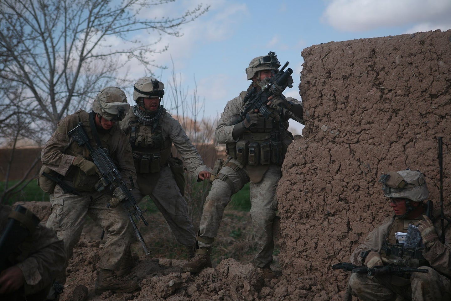 Marines with Bravo Company, 1st Battalion, 6th Marine Regiment, 2nd Marine Division, return fire during combat in Marjah, Afghanistan, Feb. 22, 2010. Marines and sailors with 1/6 took part in Operation Moshtarak, the second largest offensive in the history of Operation Enduring Freedom, aimed at wresting the city of Marjah from Taliban control. (U.S. Marine Corps photo by A.J. Lugo.)