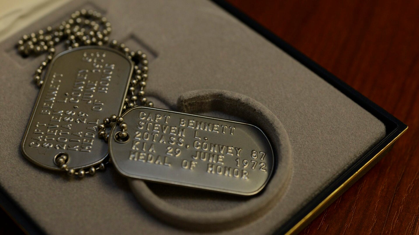 Replica dog tags for Medal of Honor recipient and OV-10 pilot Capt. Steven L. Bennett rest on a workstation at Hurlburt Field, Florida, Aug. 29, 2019. (Staff Sgt. Lynette M. Rolen/U.S. Air Force)