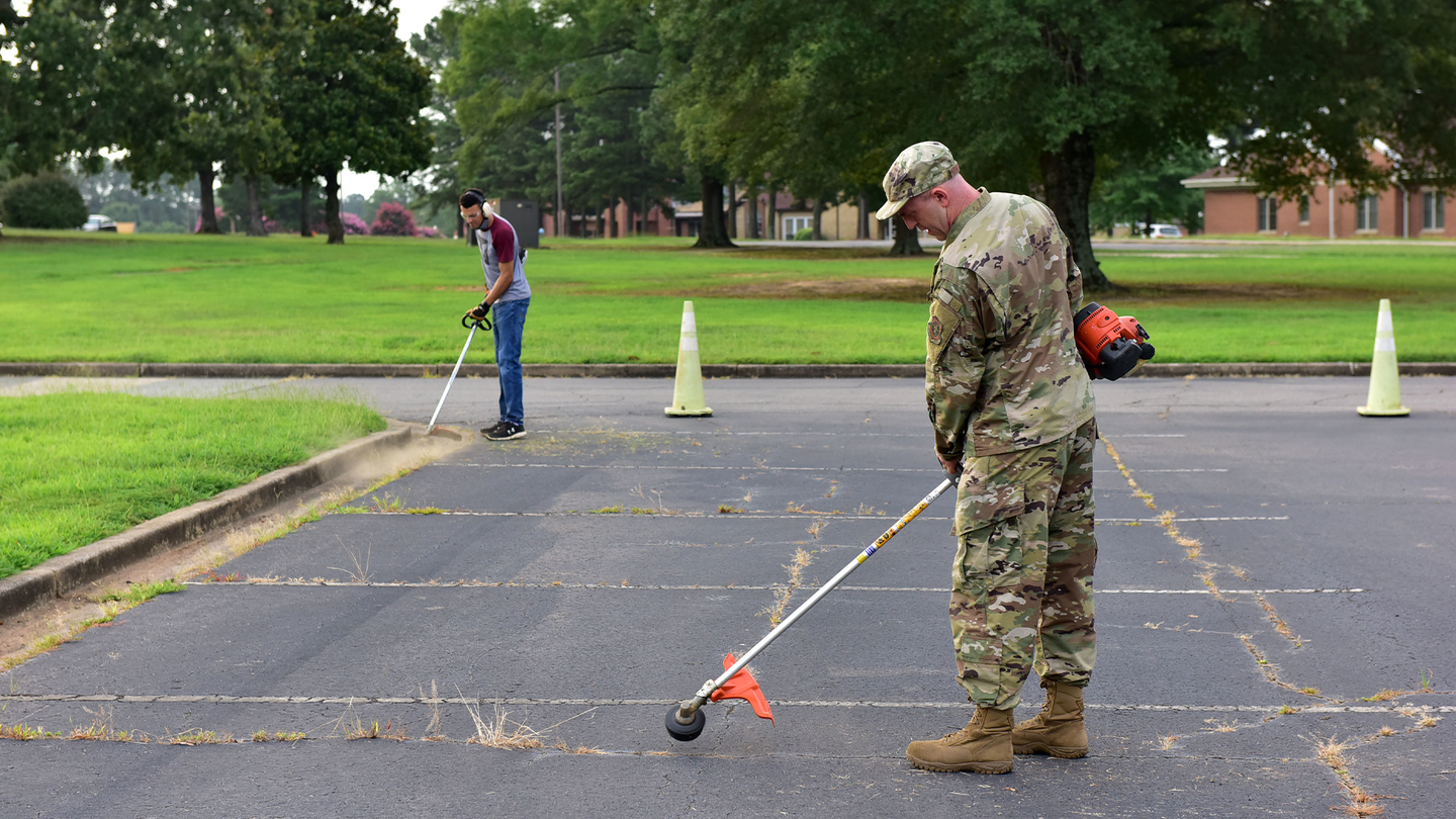 Team Little Rock Airmen help landscape the dormitory parking lot for Dorm Transform at Little Rock Air Force Base, Arkansas July 17, 2020. Landscaping and repainting the parking lots was one of many projects for the Dorm Transformation process. (U.S. Air Force photo by Airman 1st Class Isaiah Miller) 