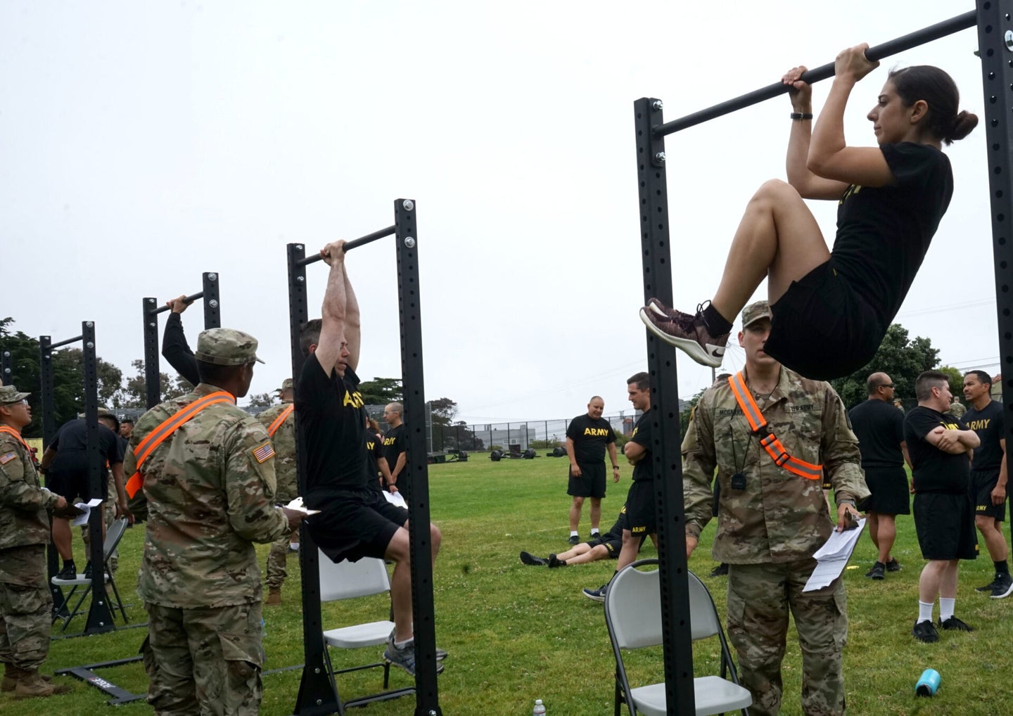 Spc. Melisa G. Flores, a paralegal specialist with the 223rd Military Intelligence Battalion, performs a leg-tuck during an Army Combat Physical Fitness test hosted at Abraham Lincoln High School in San Francisco, California, July 21, 2019. Flores, who has competed in the Best Warrior competition and won recognition for fitness, said the ACFT has challenged her in new ways.  (U.S. Army National Guard photo by Spc. Amy Carle)