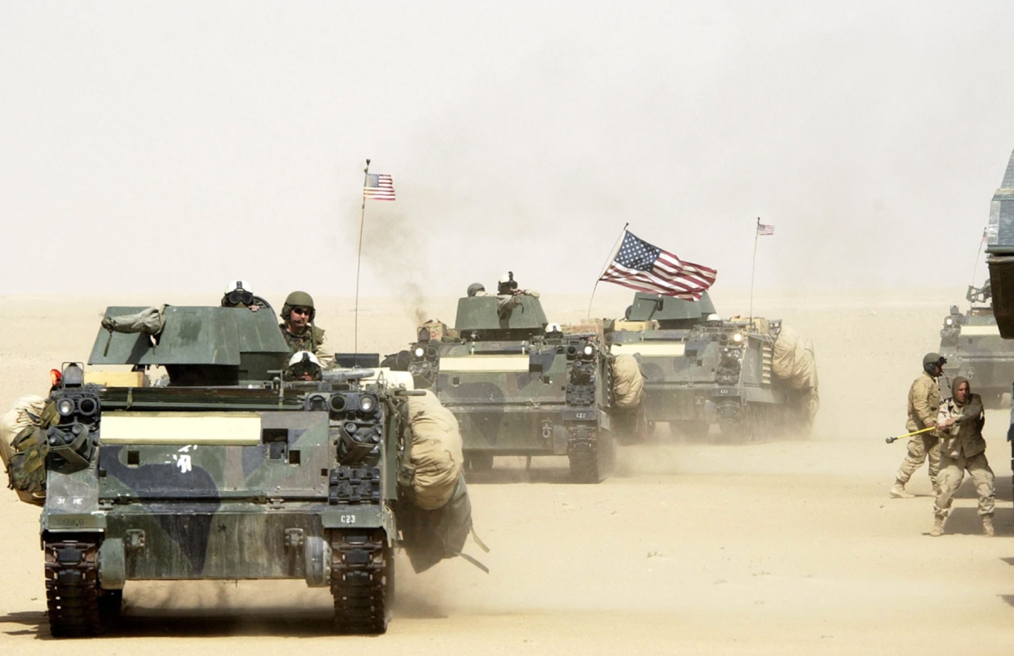 A convoy of U.S. Army 3rd Infantry Task Force 3-7 armored vehicles manuvers during a training exercise near the Iraqi border March 13th, 2003 in northern Kuwait.