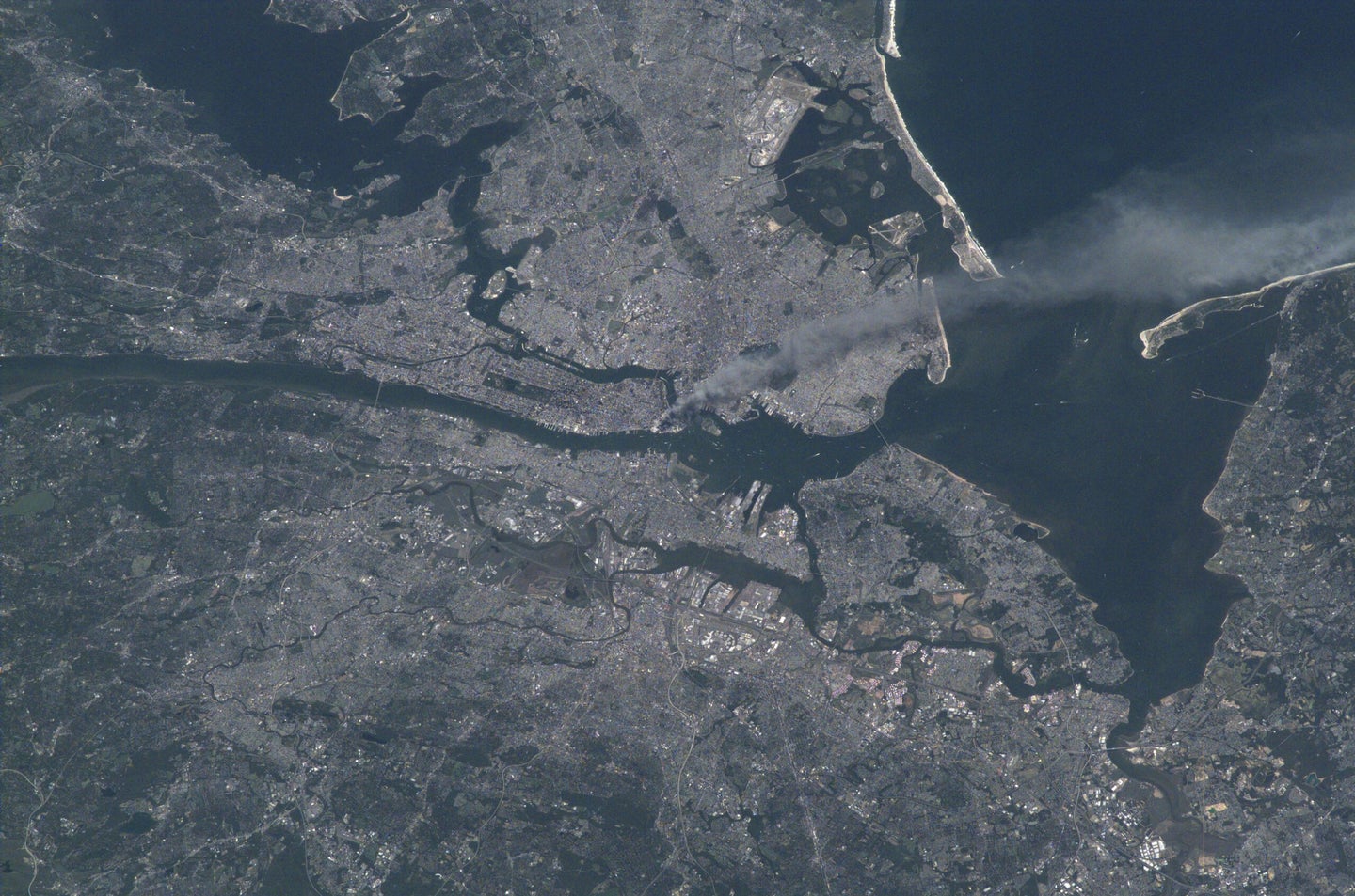 Visible from space, a smoke plume rises from the Manhattan area after two planes crashed into the towers of the World Trade Center. This photo was taken of metropolitan New York City (and other parts of New York as well as New Jersey) the morning of September 11, 2001.