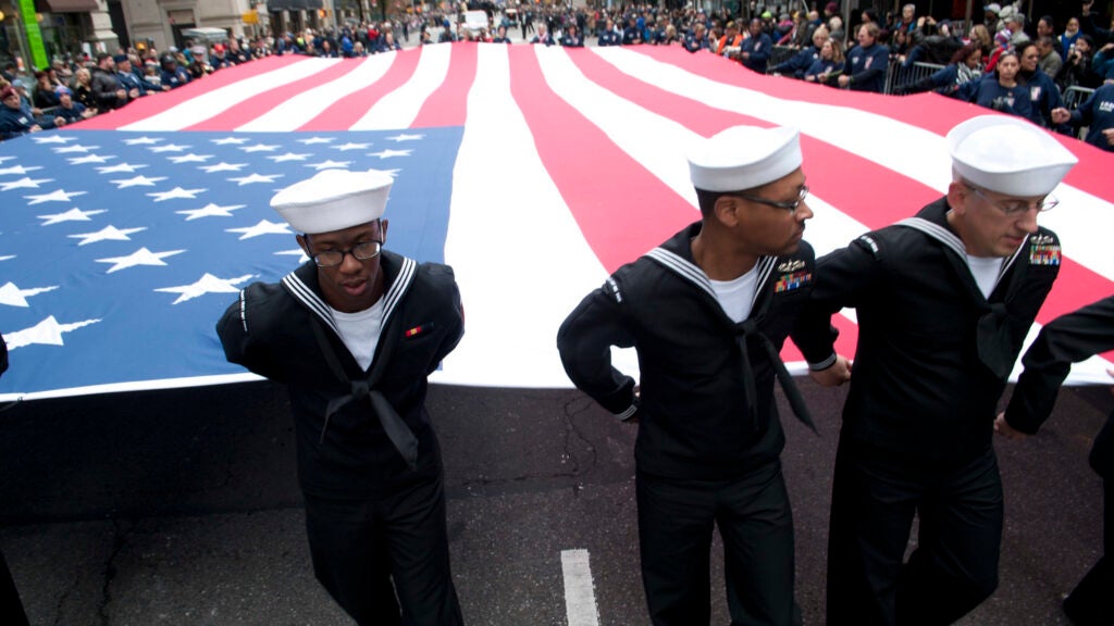 Sailors hold the national ensign as they march during the NYC Veterans Day Parade. (U.S. Navy photo by Mass Communication Specialist 1st Class Martin L. Carey)
