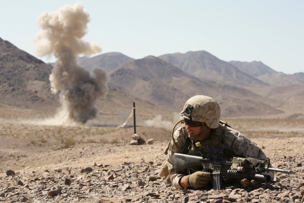 Cpl. Colton Derick lays down for cover during a simulated enemy explosion in Twentynine Palms, Calif., June 13, 2015. (Cpl. Ian Ferro/U.S Marine Corps)