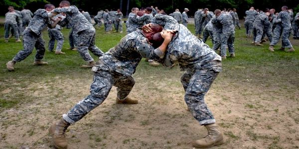 Army basic trainees practice hand-to-hand combat