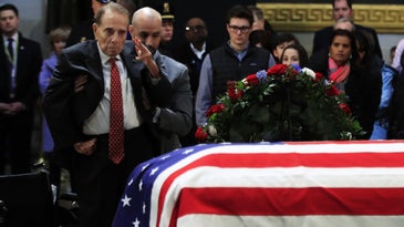 Watch Bob Dole Stand Up From His Wheelchair To Render A Final Salute To President George H.W. Bush