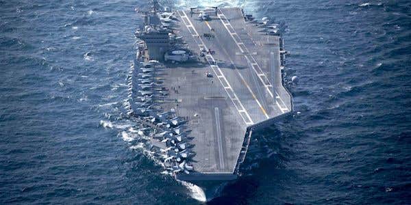 A US Aircraft Carrier Just Rolled Up In Persian Gulf Shadowed By Iranian Boats