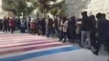 Video shows Iranian protesters refusing to walk on American and Israeli flags in Tehran