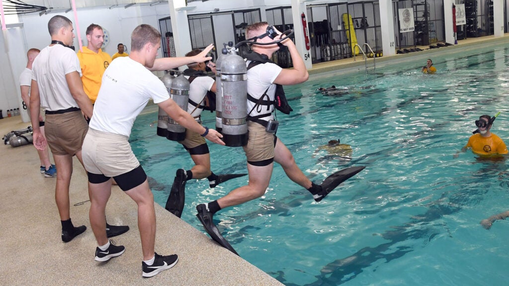 190828-N-IK959-1071 GREAT LAKES, Ill., (August 28, 2019) – Explosive Ordnance Disposal (EOD) and Navy Diver candidates train with SCUBA (Self-contained Underwater Breathing Apparatus) gear at The Center of EOD and Navy Diver Preconditioning and Assessment on Naval Station Great Lakes, Illinois. Rear Adm. Jamie Sands, commander, Naval Service Training Command (NSTC), and a Special Operator (SEAL), visited the center and pool (80H) to see the training and talk with facilitators about how they train and assess future EOD members and Navy Divers to see if the students are capable to continue on with follow-on training at the Navy Diver and EOD schools in Panama City, Florida, and Eglin Air Force Base in Fort Walton Beach, Florida. (U.S. Navy photo by Scott A. Thornloom/Released)