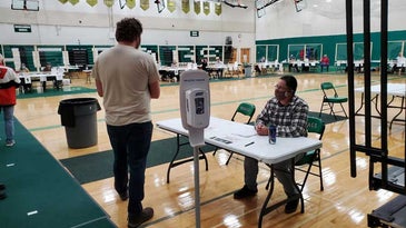 Army National Guardsmen are working at election polling sites out of uniform