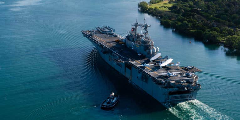 A Navy flattop just rolled up in Hawaii laden with World War II-era warbirds