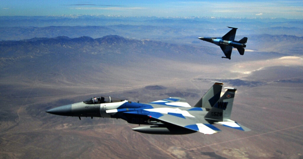 A U.S. Air Force F-15E and two F-16's  from the 65th Aggressor Squadron break formation after a dogfight against members of the Air Force Weapons School over Nellis Air Force Base, Nev., May 17, 2012. The Air Force Weapons School is a five-and-a-half-month training course which provides selected officers with the most advanced training in weapons and tactics employment. Throughout the course, students receive an average of 400 hours of post graduate-level academics and participate in demanding combat training missions.

(U.S. Air Force photo/Airman 1st Class Matthew Bruch)(Released)