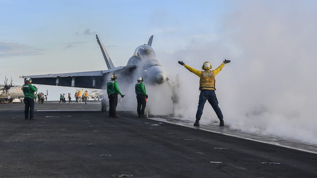 Sailors prepare to launch an F/A-18F Super Hornet assigned to the "Mighty Shrikes" of Strike Fighter Attack Squadron (VFA) 94 from the flight deck of the aircraft carrier USS Theodore Roosevelt (CVN 71). (Mass Communication Specialist 3rd Class Spencer Roberts/U.S. Navy)