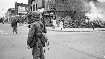 Black and White Photo of Solider on Street