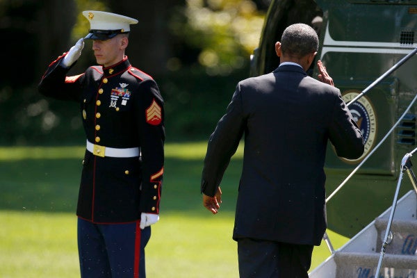 President Barack Obama returns a Marine's salute