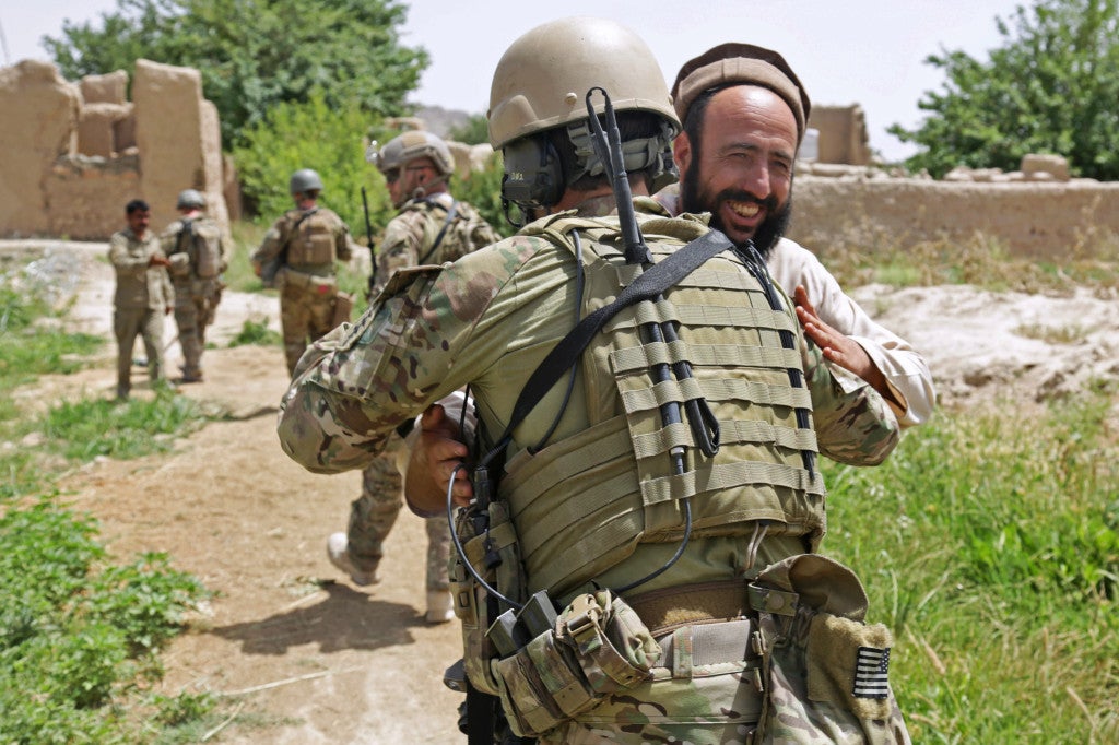 A U.S. Special Forces team leader meets with an Afghan Local Police checkpoint commander in Zharay district, Kandahar province, Afghanistan, May 21, 2013. His team conducts regular visits to ALP checkpoints in the area to ensure their progress in providing security to the local villages by denying enemies of Afghanistan access to the local population. (U.S. Army photo by Staff Sgt. Kaily Brown/ Released)