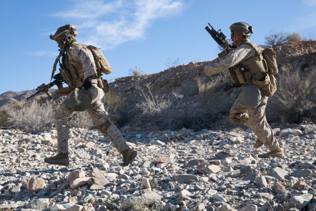 U.S. Marine Corps Sgt. Robert Peas (left) and Lance Cpl. Cameron O’Hara (right), infantry Marines with 2nd Battalion, 5th Marine Regiment, 1st Marine Division, sprint to cover during the Integrated Training Exercise (ITX) at Marine Air Ground Combat Center Twentynine Palms, California, Jan. 25, 2020. ITX is a month-long training event that applies combined-arms maneuver and offensive and defensive operations to prepare Marines for deployment. (U.S. Marine Corps photo by Cpl. Jack C. Howell)