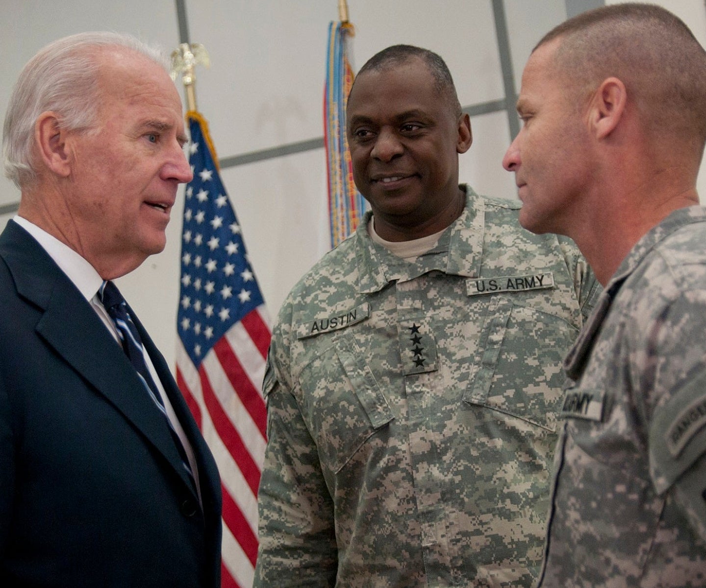 Vice President Joe Biden talks with United States Forces Iraq commander, Gen. Lloyd J. Austin III, and Command Sgt. Maj. Earl Rice of the 18th Airborne Corps, after unveiling the Medal of Commitment. Dec. 1, 2011, marks Iraq's Day of Commitment. The ceremony hosted by the Iraqi government at Al Faw Palace, in Baghdad, Iraq would be the last of it's kind as U.S. forces continue to draw out of Iraq. U.S. Vice President Joe Biden, took the opportunity to thank U.S. and Iraqi service members for all of their sacrifices that led to the end of an almost decade long war.