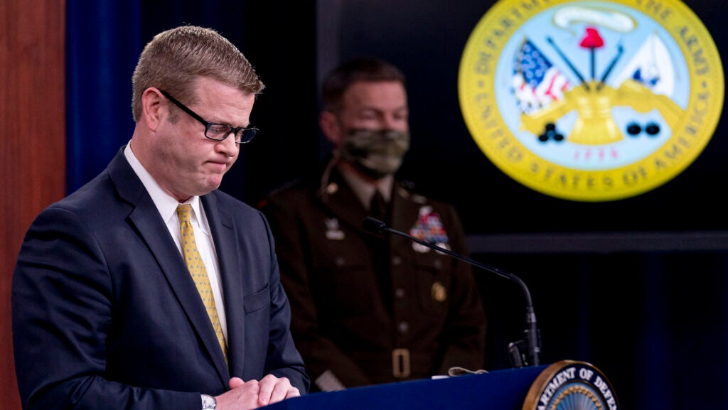 Secretary of the Army Ryan McCarthy, left, accompanied by Gen. James McConville, Chief of Staff of the Army, right, pauses while speaking about an investigation into Fort Hood, Texas at the Pentagon, Tuesday, Dec. 8, 2020, in Washington. The Army says it has fired or suspended 14 officers and enlisted soldiers at Fort Hood, Texas, and ordered policy changes to address chronic leadership failures at the base that contributed to a widespread pattern of violence including murder, sexual assaults and harassment. (AP Photo/Andrew Harnik)