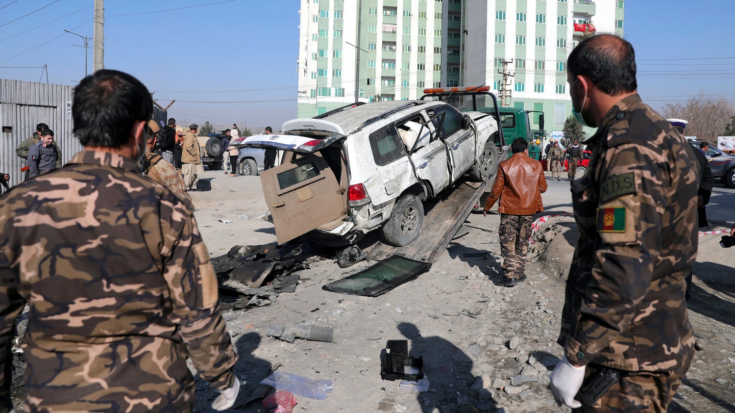 Afghan security personnel inspect the site of a bomb attack in Kabul, Afghanistan, Tuesday, Dec. 15, 2020. A bombing and a shooting attack on Tuesday in the Afghan capital of Kabul killed a few people, including a deputy provincial governor, officials said.(Associated Press/Rahmat Gul)
