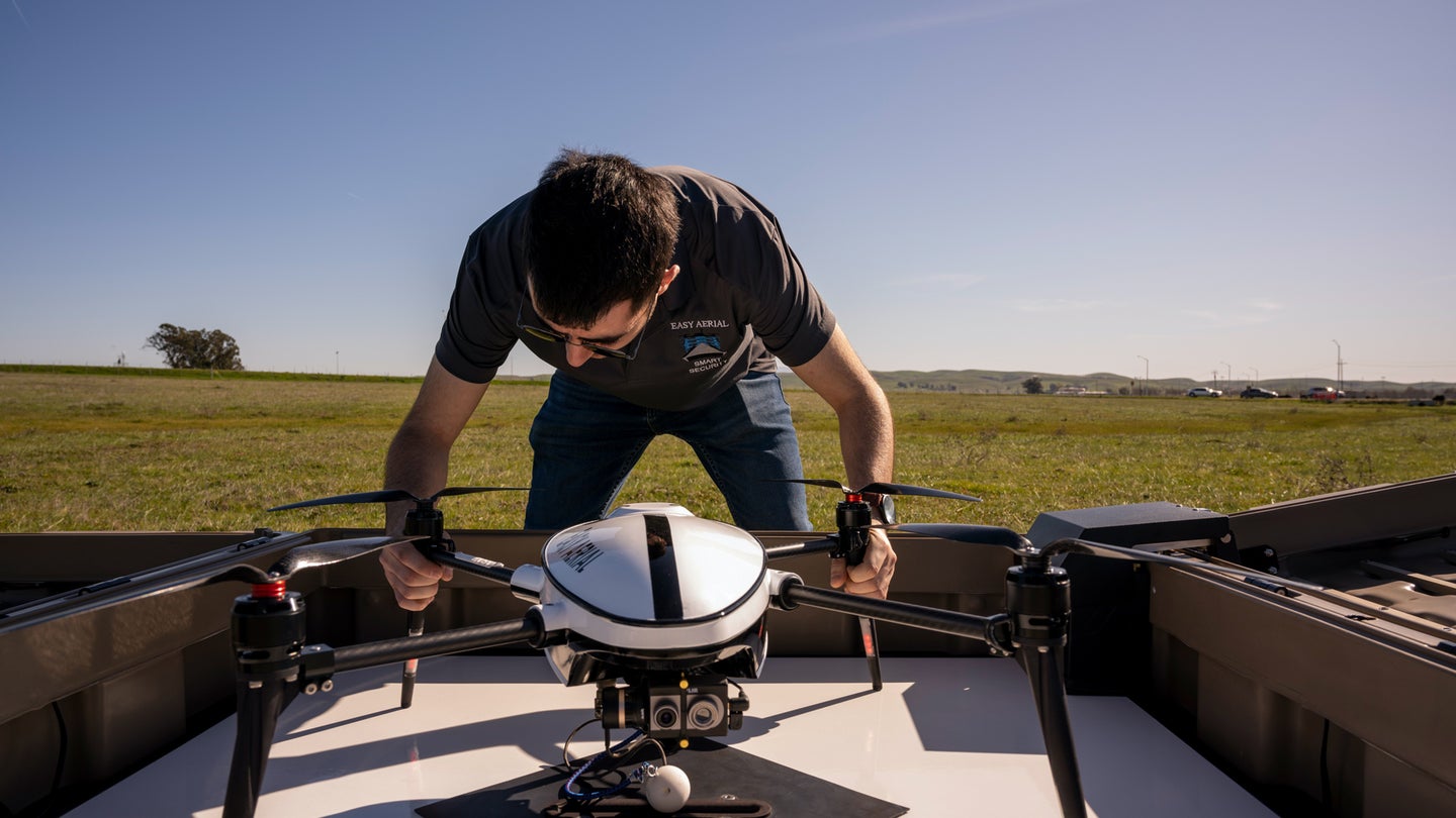 Vazgen Petrosyan, engineer for the Easy Aerial drone, inspects the drone before a test flight at Travis Air Force Base, California, Feb. 25, 2020. The drone would give security forces Airmen an option for quick response to various scenarios or events on Travis AFB. (Air Force photo / Nicholas Pilch)