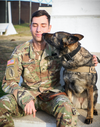 Cpl. Dustin Borchardt, a military dog handler with the 100th Military Police Detachment based out of Stuttgart, Germany, poses with his military working dog named Pearl at Camp Bondsteel, Kosovo, on Dec. 8, 2020. (Army National Guard photo / Staff Sgt. Tawny Schmit)