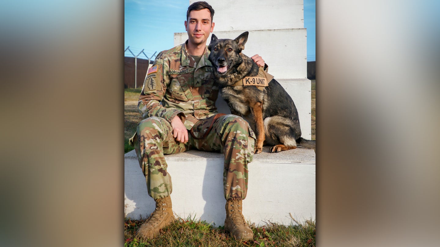 Army Cpl. Dustin Borchardt, a military dog handler with the 100th Military Police Detachment based out of Stuttgart, Germany, poses with his military working dog named Pearl at Camp Bondsteel, Kosovo, on Dec. 8, 2020. (Army National Guard photo / Staff Sgt. Tawny Schmit)