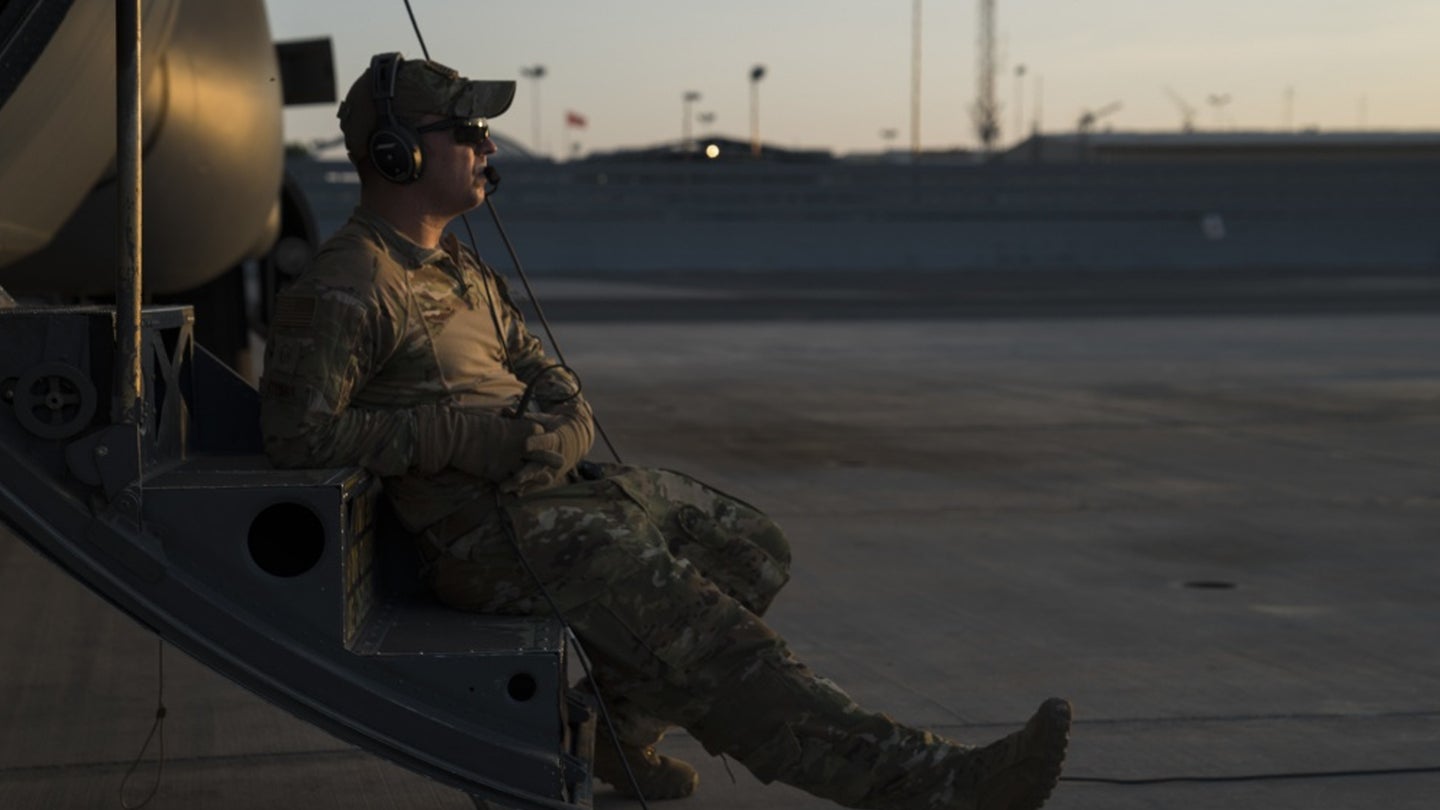 U.S. Air Force Master Sgt. Lance Stump, loadmaster, assigned to the 75th Expeditionary Airlift Squadron (EAS), sits on the crew door steps of a C-130J Super Hercules during sunset at Camp Lemonnier, Djibouti, on December 6, 2019. (Air Force photo / Tech. Sgt. Nick Kibbey)