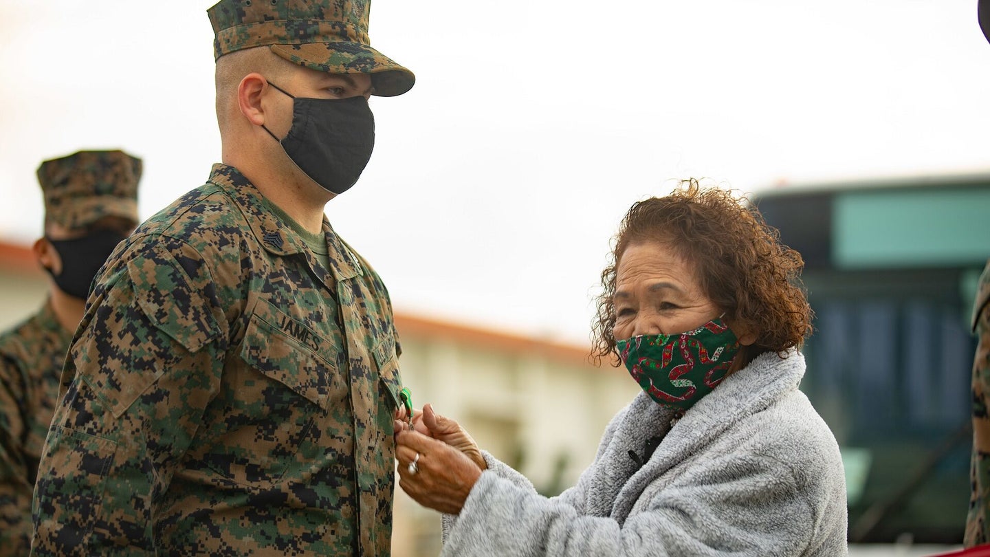 Sgt. John James, a motor vehicle operator with Combat Logistics Battalion 31, 31st Marine Expeditionary Unit (MEU), is awarded the Navy Achievement Medal for saving Tokiko Ahuso, a local Kin Town resident who was bitten by a habu viper on Nov. 6, at Camp Hansen, Okinawa, Japan, Dec 23, 2020. The 31st MEU, the Marine Corps’ only continuously forward-deployed MEU, provides a flexible and lethal force ready to perform a wide range of military operations as the premier crisis response force in the Indo-Pacific region. (U.S. Marine Corps photo by Cpl. Brandon Salas)