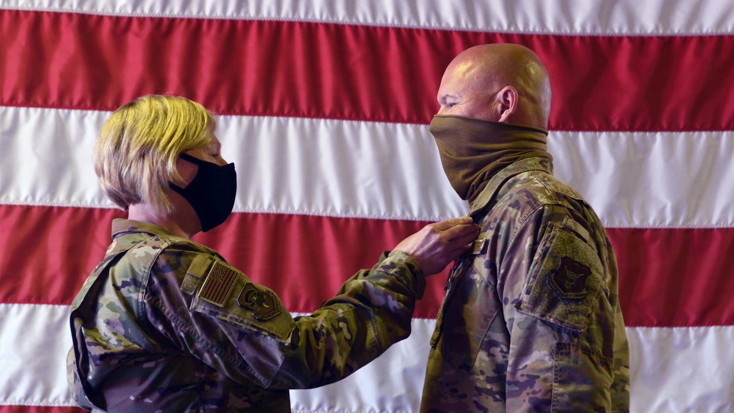 Col. Ann Brown, 459th Mission Support Group commander, pins the Bronze Star on Senior Master Sgt. Rick Johnson, 69th Aerial Port Squadron operations flight chief, during a ceremony Oct. 3rd, 2020, at Joint Base Andrews, Md.