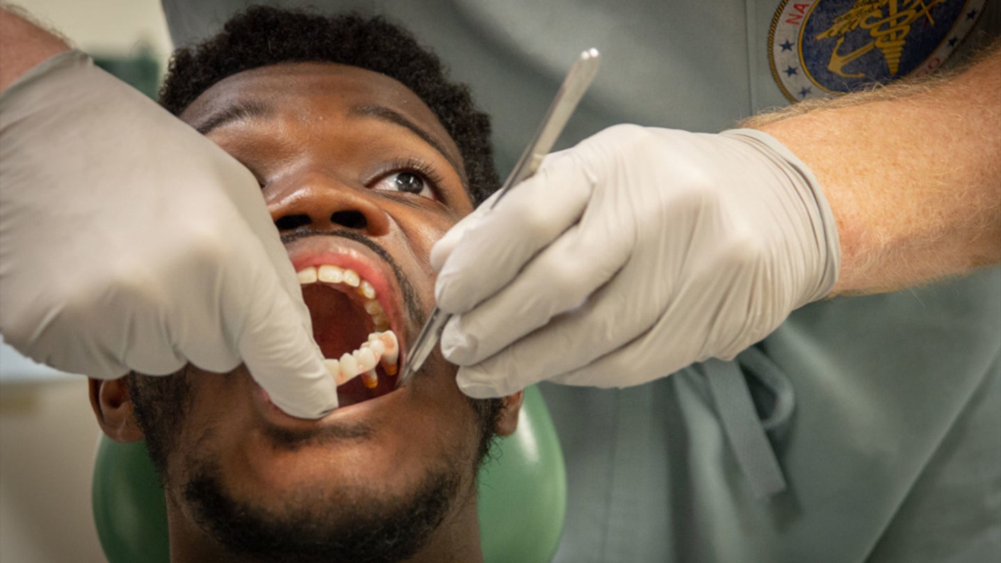 Lance Cpl. Jaden Murry's prosthetic denture and oral cavity are inspected in Naval Medical Center San Diego’s (NMCSD) Dental Department approximately six weeks after an immediate jaw replacement surgery Dec. 29. (Navy photo / Mass Communication Specialist 3rd Class Jake Greenberg)