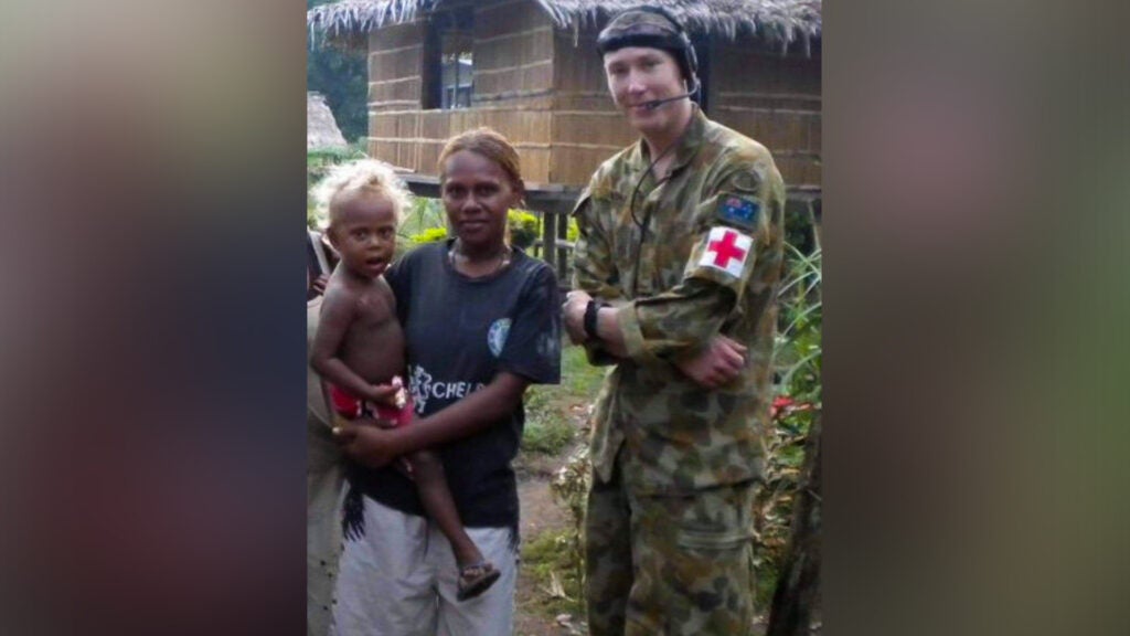Sgt. Abraham Boxx, a critical care flight paramedic with the 1st Battalion, 168th General Support Aviation Battalion, Washington Army National Guard, poses for a photo with a local during a deployment to the Solomon Islands in 2010. Boxx served in the Australian Defense Force from 2007 to 2016 and deployed three times as a combat medic before joining the Washington Army National Guard. (Courtesy photo)