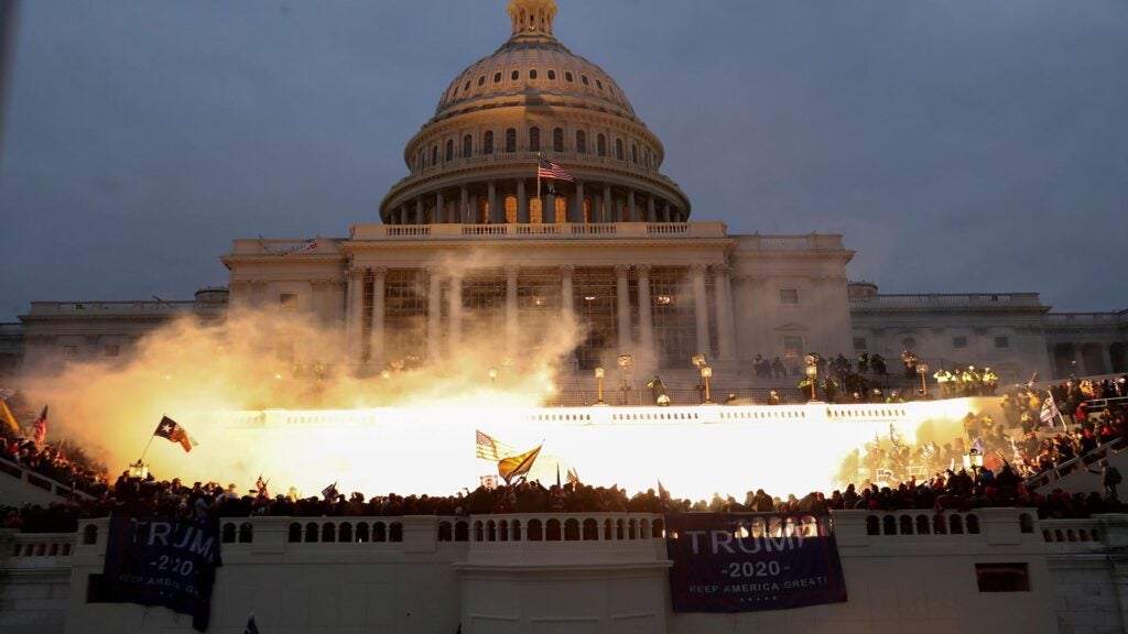 FILE PHOTO: An explosion caused by a police munition is seen while supporters of U.S. President Donald Trump gather in front of the U.S. Capitol Building in Washington, U.S., January 6, 2021. REUTERS/Leah Millis/File Photo