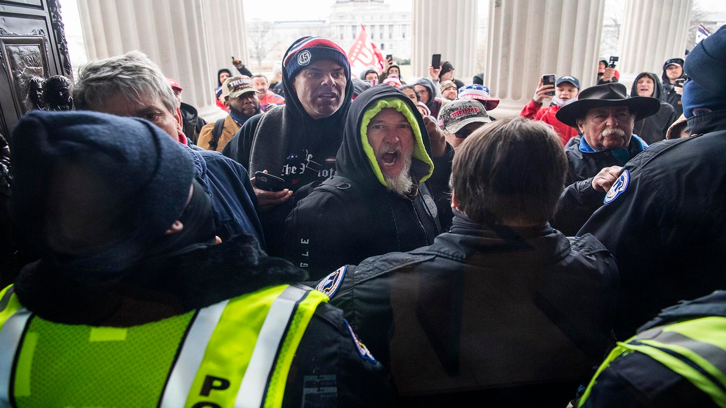UNITED STATES - JANUARY 6: Rioters attempt to enter the Capitol at the House steps during a joint session of Congress to certify the Electoral College vote on Wednesday, January 6, 2021. (Photo By Tom Williams/CQ Roll Call via AP Images)