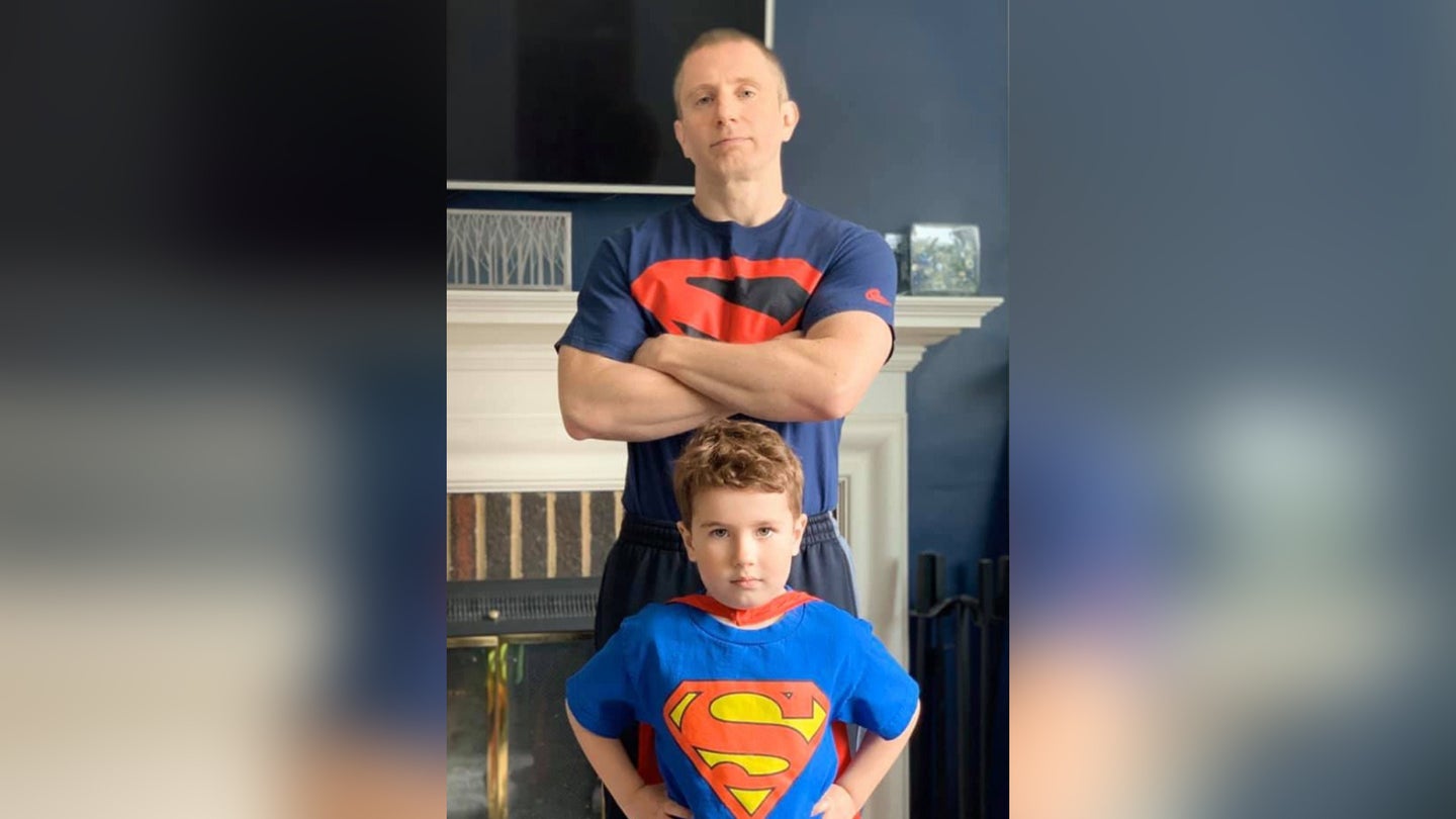 Sgt. 1st Class Phillip Kennedy Johnson, pictured with his son, Anders, at his Baltimore-area home, is the new author of DC Comics' Superman and Action Comics