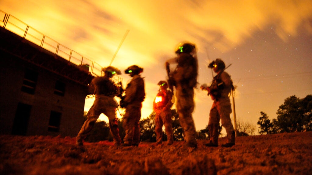A squad of U.S. Navy SEALs participate in special operations urban combat training. The training exercise familiarizes special operators with urban environments and tactical maneuvering during night and day operations.